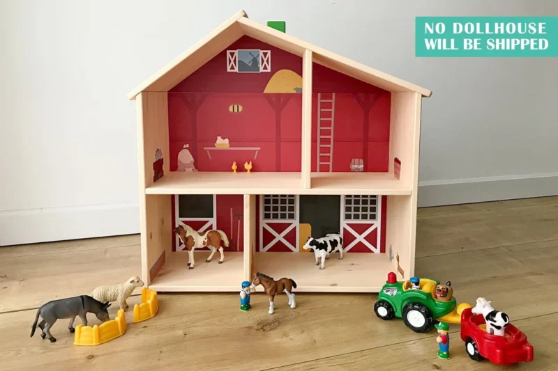 A small wooden dollhouse with 4 different sized compartments is setup to look like a barn.