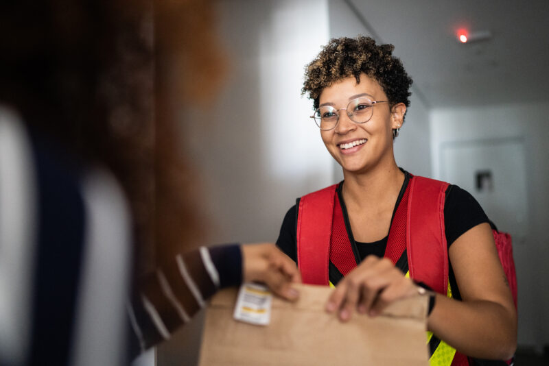 Woman receiving delivery at home Woman receiving delivery at home