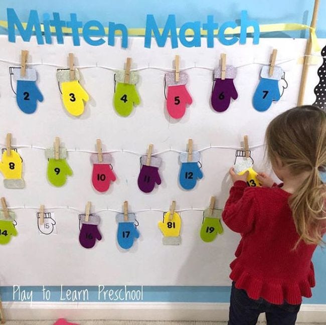 Interactive Bulletin Boards Play to Learn Preschool IG Child matching colored mittens with numbers on them on a bulletin board