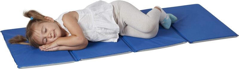 Mat A little girl is seen resting on a long blue mat.