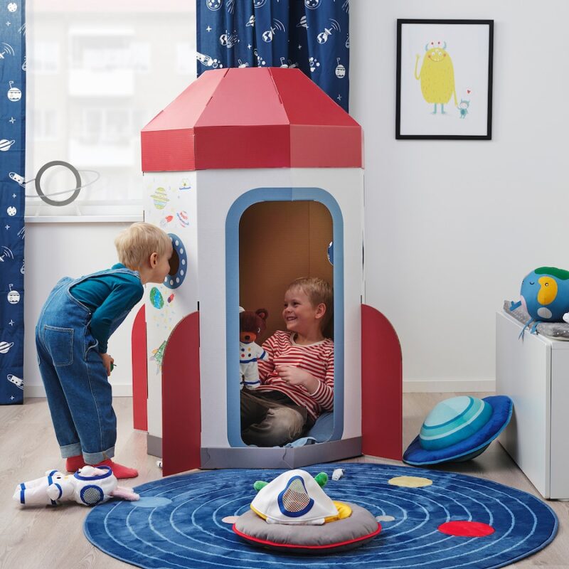 Rocketship-1 Two small children play inside a cardboard rockets hip tent in this example of Ikea classroom