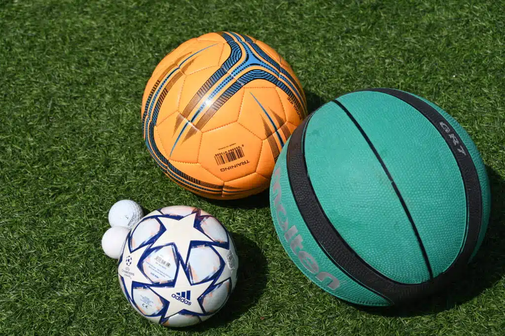 balls An assortment of different size balls on the grass