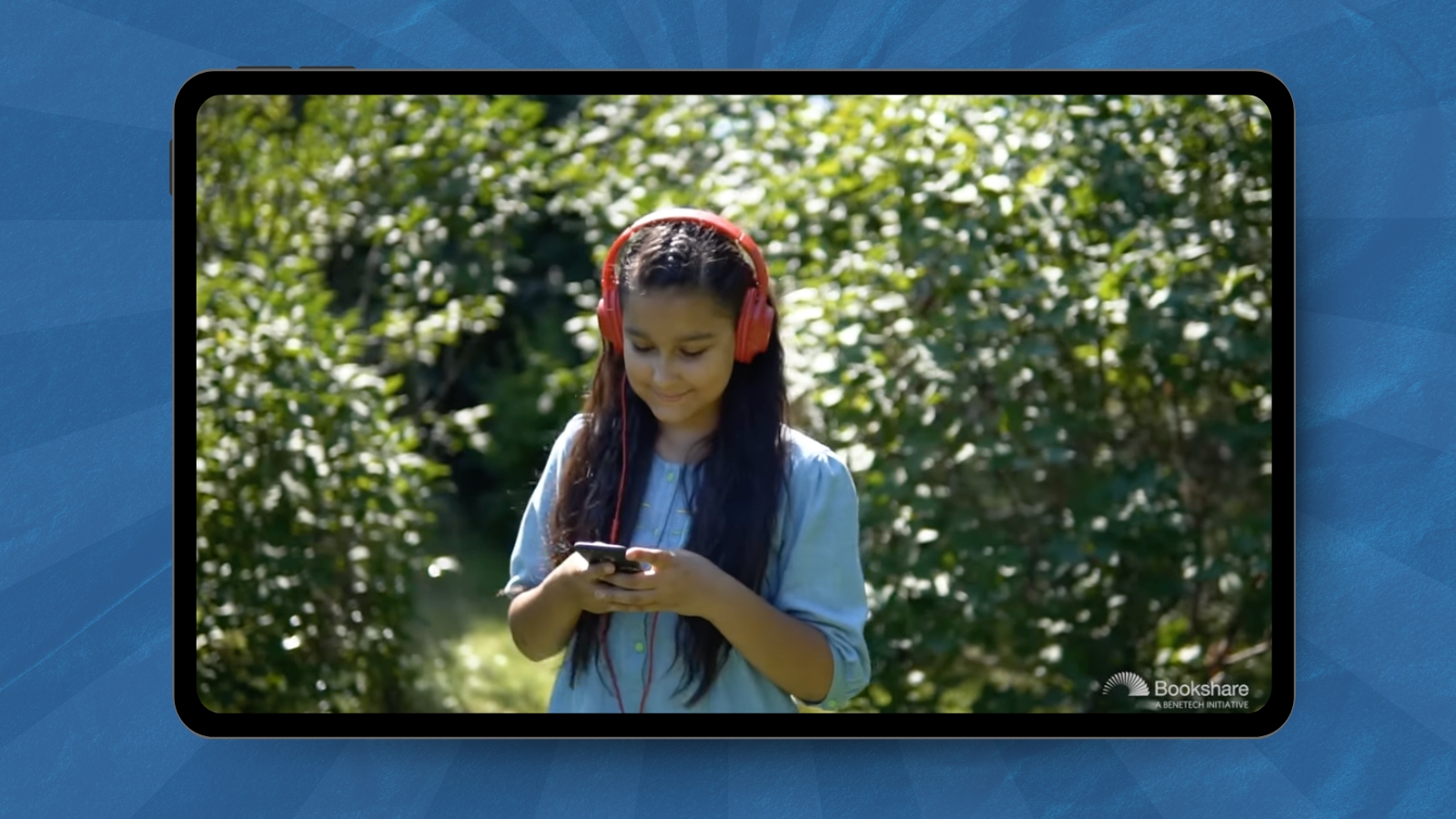 tween looking at her phone with headphones on