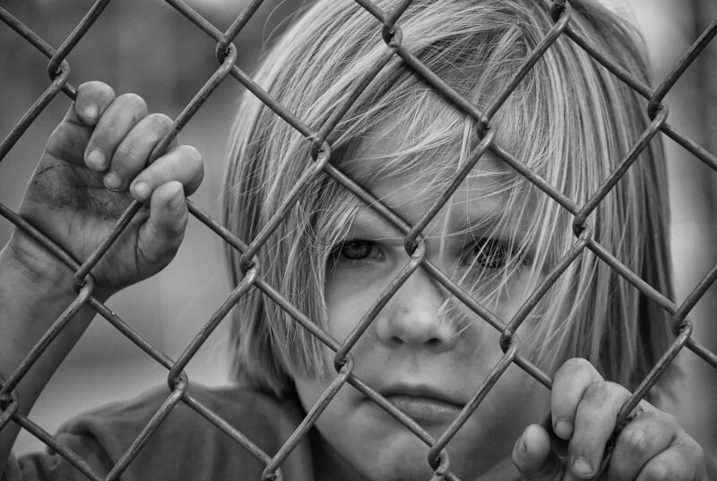 Picture Prompt: Face in a Fence Child with their face pressed up against a wire fence