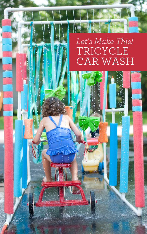 car-wash child driving a tricycle through a car wash made from p v c pipes and pool noodles for a water activity