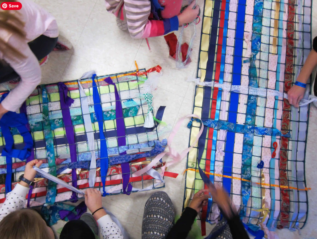 Collaborative Weaving Fifth grade art students weaving fabric and ribbon through plastic garden fencing