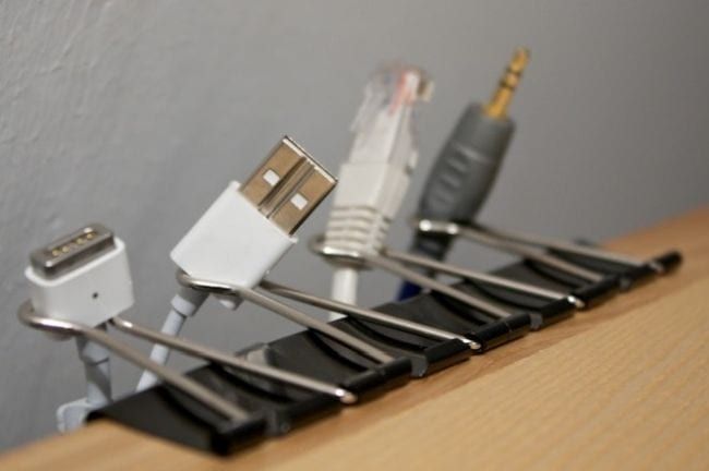 Dollar Store Hacks: Binder Clip Cables Binder clips holding charging cables to the edge of a table
