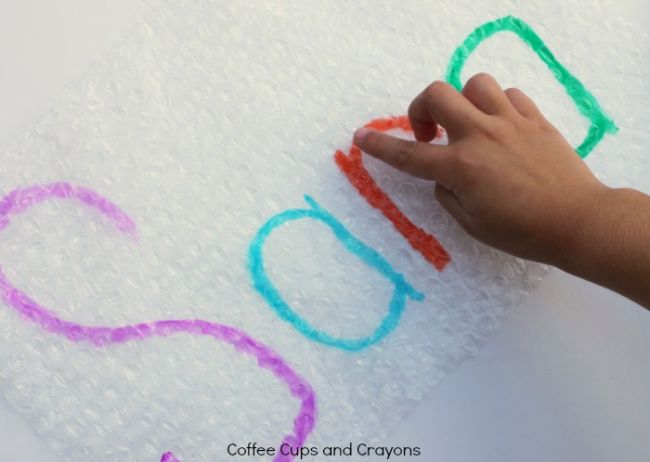 Dollar Store Hacks: Bubble Wrap Student popping bubbles on bubble wrap while tracing the letters of the name Sara as an example of dollar store hacks for the classroom