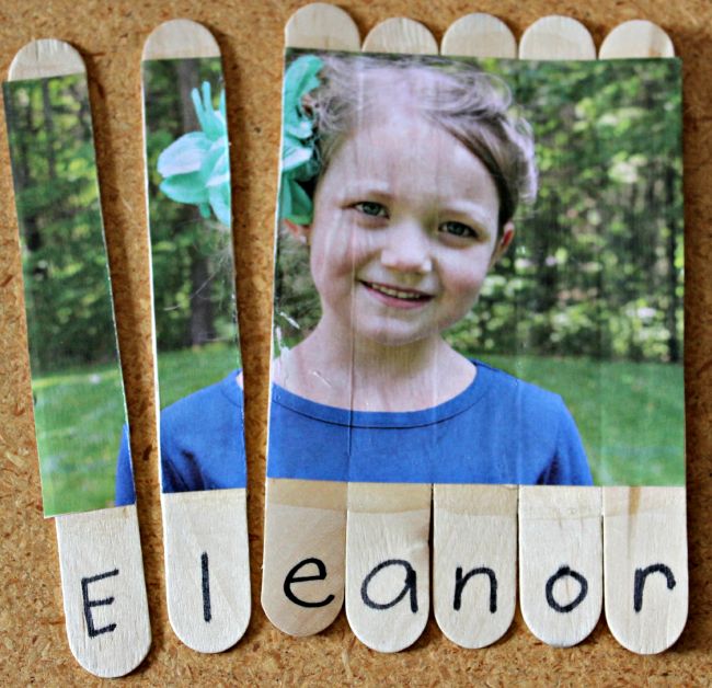 Dollar Store Hacks: Craft Stick Puzzle Child's picture glued to a series of wood craft sticks and cut apart, with the letters of her name underneath