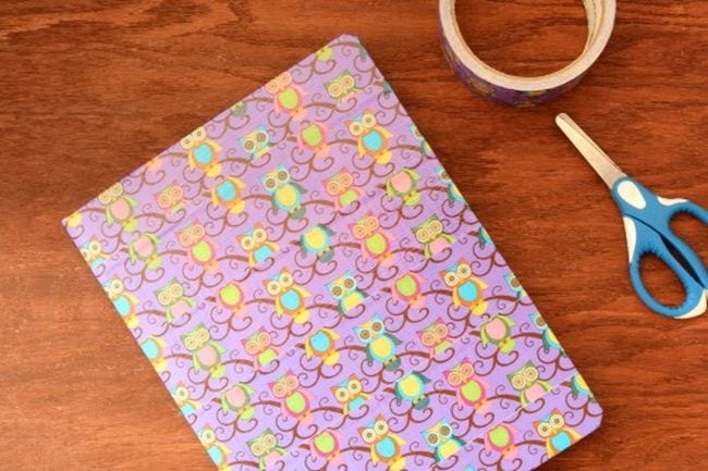 Dollar Store Hacks: Duct Tape Notebooks Composition book covered in owl-printed duct tape, with tape roll and scissors
