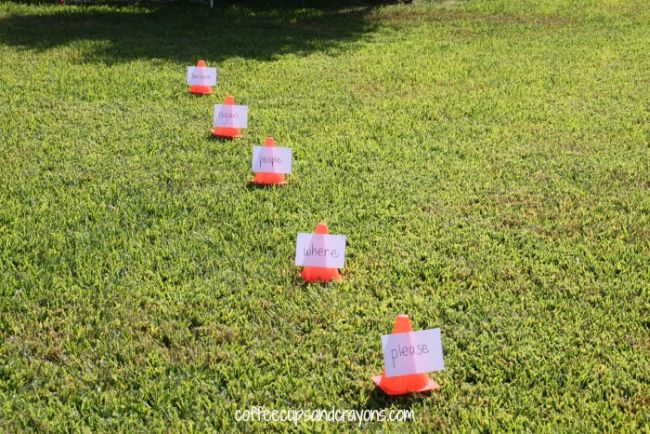 Dollar Store Hacks: Sight Word Soccer Series of small orange cones with words taped to them laid out on grass as an example of dollar store hacks for the classroom