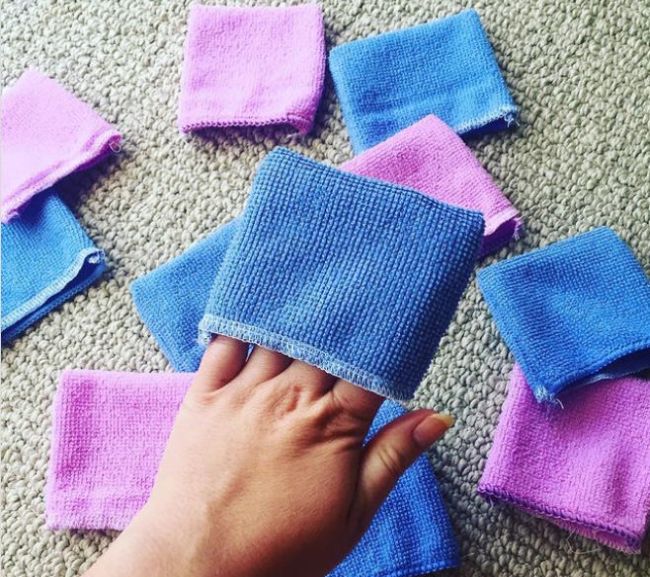 Dollar Store Hacks: Eraser Mitts Teacher holding blue and pink eraser mitts made from microfiber cloth as an example of dollar store hacks for the classroom
