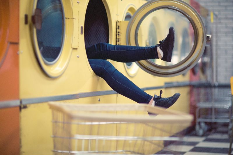 Picture Prompt: Dryer Legs A pair of legs waving out of a dryer in a laundromat