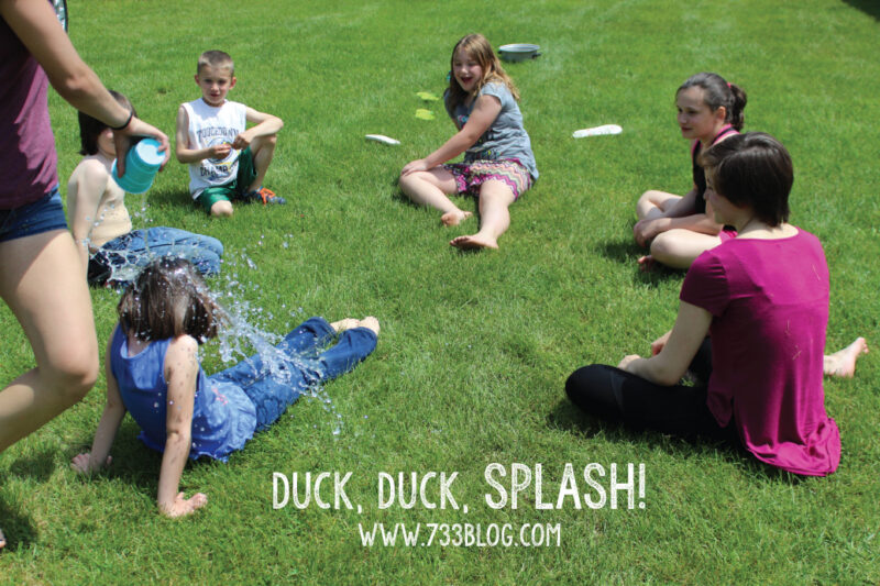 Duck Duck Splash children sitting in a circle for a water game duck duck splash