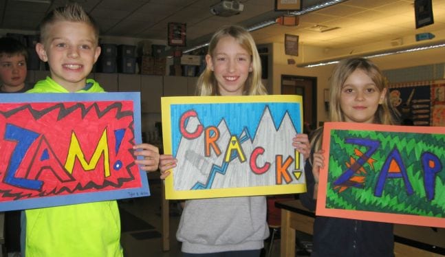 Fifth Grade Art Onomatopoeia Art Fifth grade art students holding illustrations of the words Sam, Crack, and Zap