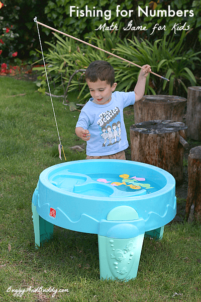 fishing-for-numbers boy fishing with a toy fishing rod in a baby pool