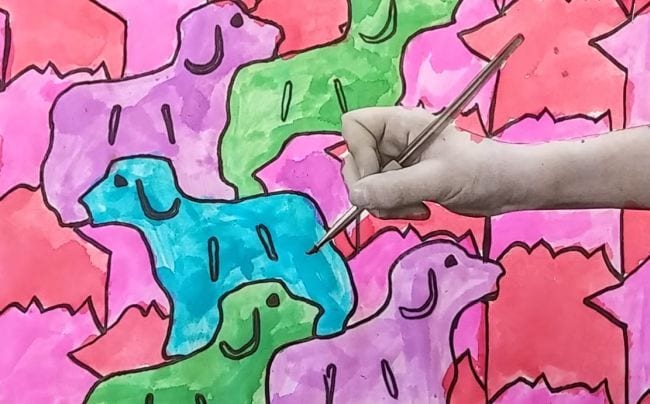 Fourth Grade Art Escher Tessellations Tessellated dogs bright colors with the image of a child's handing holding a pencil pasted on top