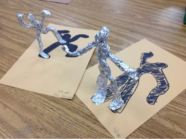 Fourth Grade Art Foil Sculptures Two figures sculpted from aluminum foil, with their shadows drawn below