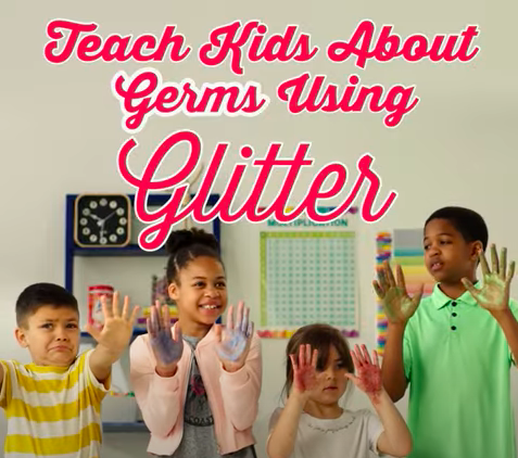 glitter-germs Kids hold up their hands, which are covered in glitter, in front of them