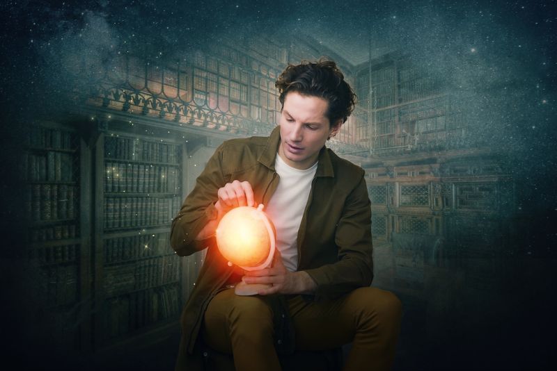 Writing Prompts: Glowing Globe Man holding a glowing globe in a misty library