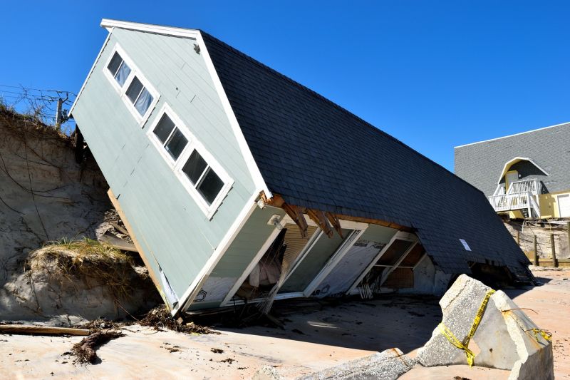 Picture Prompt: Hurricane House House tipped on its side following a hurricane