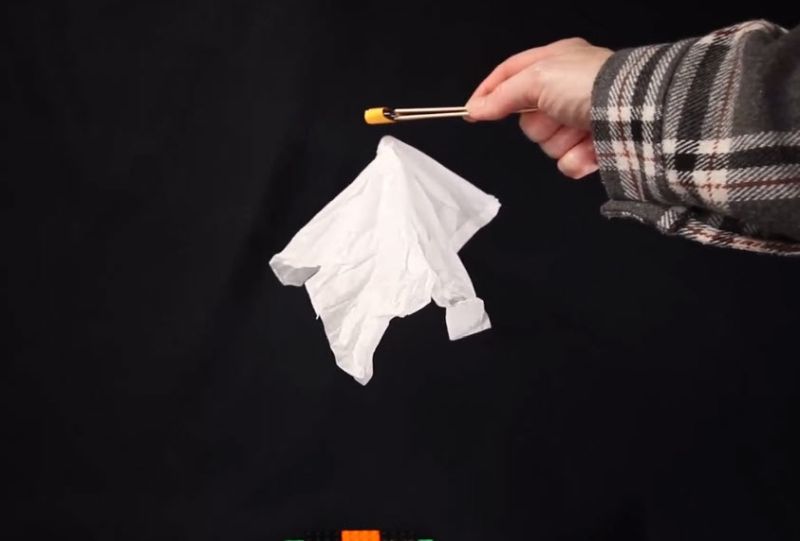 ghost-magnet Child using a magnet to make a tissue paper "ghost" float in the air