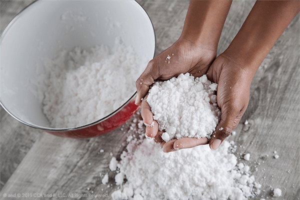 artificial-snow Hands shown holding artificial snow from a pile as an example of science activities for preschoolers.