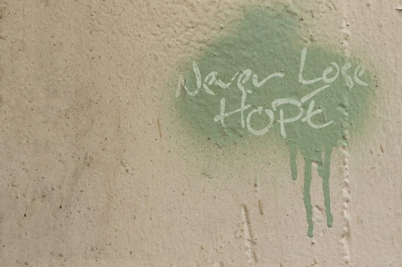 Writing Prompt: Never Lose Hope Splotch of green paint with the words "Never Lose Hope" scrawled in it