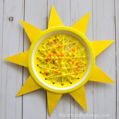 paper plate sun Yellow paper plate with colored paper shaped like rays of the sun around the border and yarn and beads strung across the middle