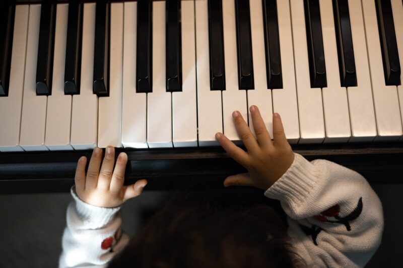 Picture Prompts: Piano Keyboard A young child's hands on a piano keyboard