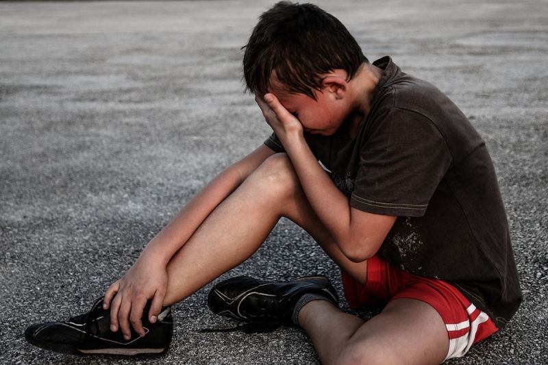 Picture Writing Prompts: Boy Boy sitting on the ground with his face in his hands