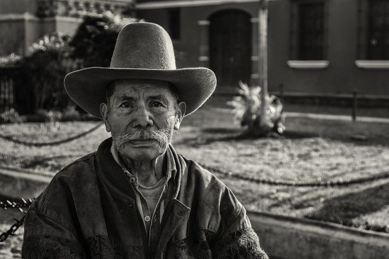 Picture Writing Prompts: Man An old man wearing a cowboy hat sits in front of a house (Picture Writing Prompts)