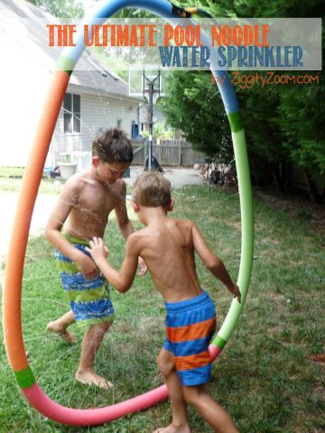 pool-noodle-sprinkler boy jumping through a sprinkler made of pool noodles for a water activity