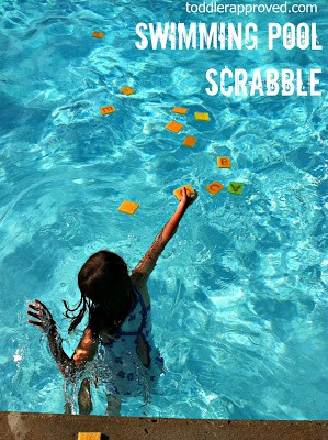 Pool-Scrabble child throwing sponges into a pool