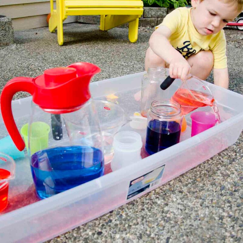 pouring-station boy playing with jugs of water