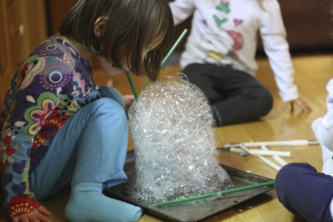 bubble-towers Preschool science student blowing a tower of soap bubbles as an example of science activities for preschoolers