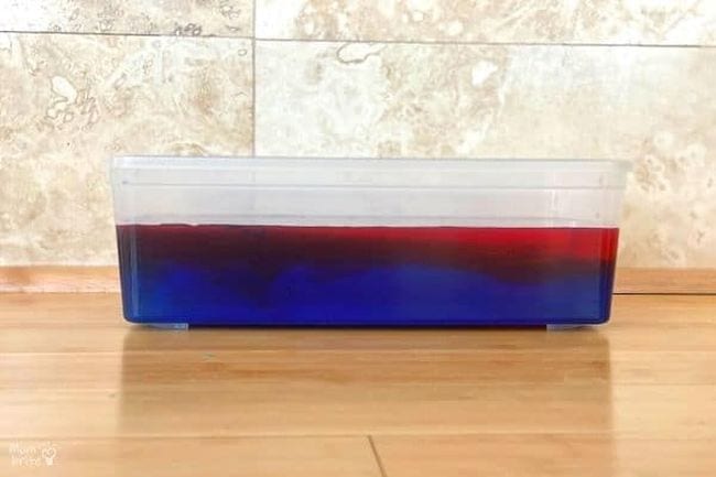 hot-cold-water Plastic bin of colored water, with red on top and blue on the bottom as an example of science activities for preschoolers