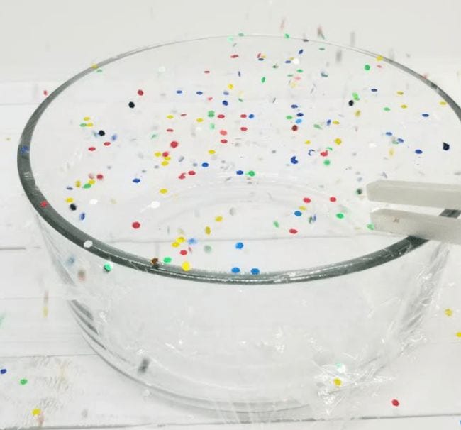preschool-science-sound-waves Glass bowl covered in plastic wrap with confetti on top, and a tuning fork touching the plastic