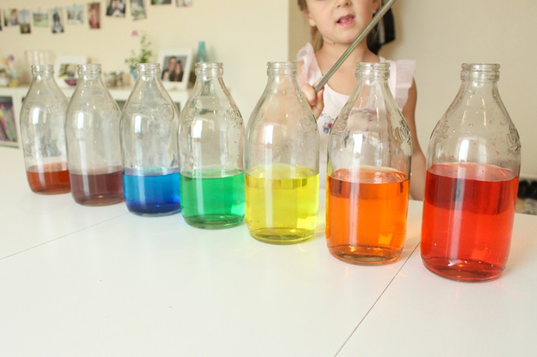 rainbow-xylophone Child standing behind row of glass jars with colored water in them as an example of science activities for preschoolers