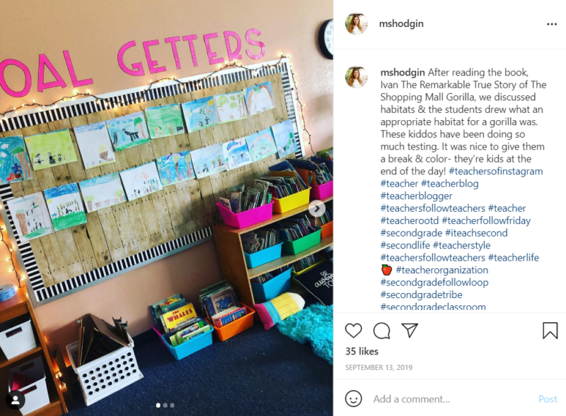 Student illustrations of books hanging on a classroom wall