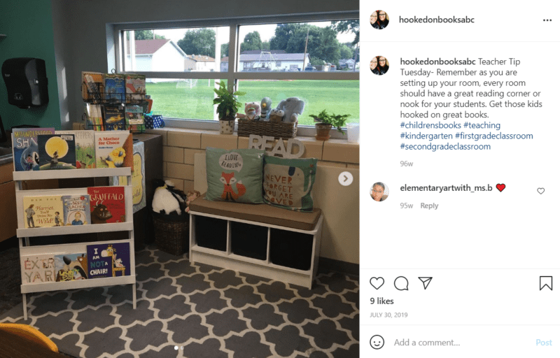 Book nook by a classroom window with books and seating