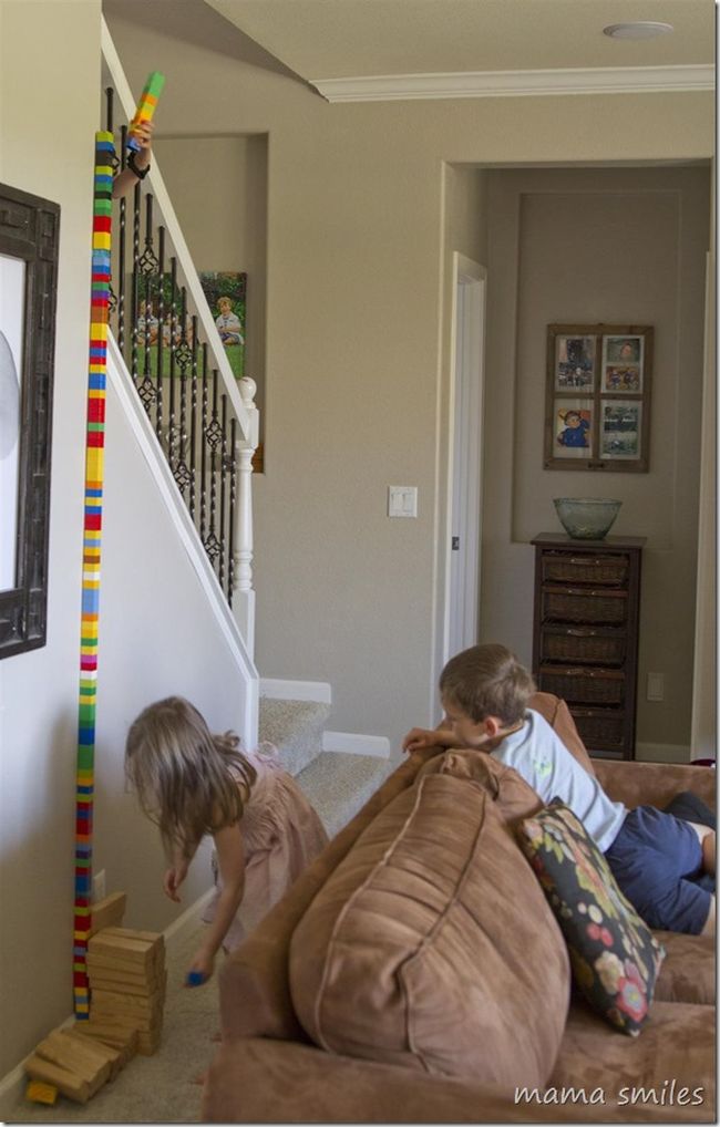 tall-tower Children building a tower to the ceiling using building blocks