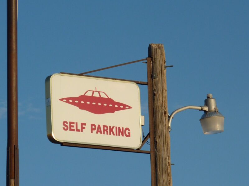 Picture Prompt: UFO Parking Sign saying UFO Parking with picture of a flying saucer