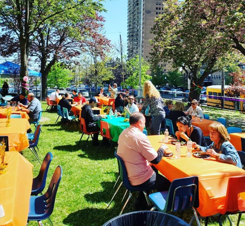 Teacher Appreciation Week Cookout Teachers eating lunch outdoors at colorful tables for Teacher Appreciation Week