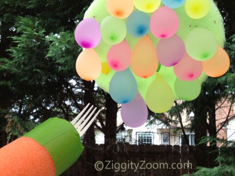 water-balloon-joust water squirter with a fork in the top pointed at a bunch of water balloons