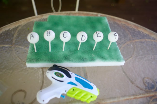 water-gun-target ping pong balls with letters and a squirt water gun