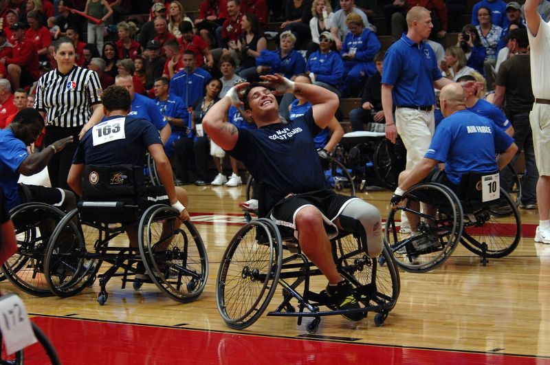 Writing Prompts: Wheelchair basketball Men in wheelchairs playing basketball, as one laments a missed shot
